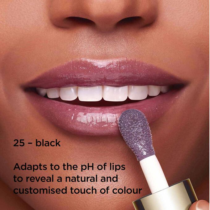 Close-up of smiling lips to showcase the texture and colour of the black lip oil shade on her skin tone that reacts to lips' pH